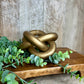 GOLD LINKED WOOD KNOT DECOR